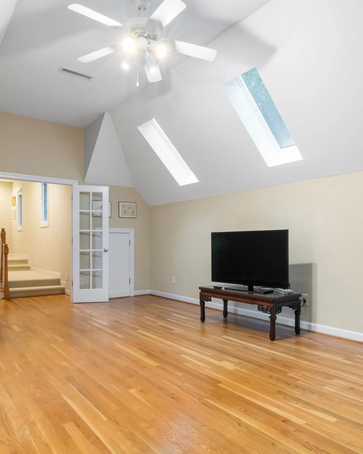 A clean, bright attic bonus room with skylights and hardwood floors, for attic mold removal in Falls Church, VA