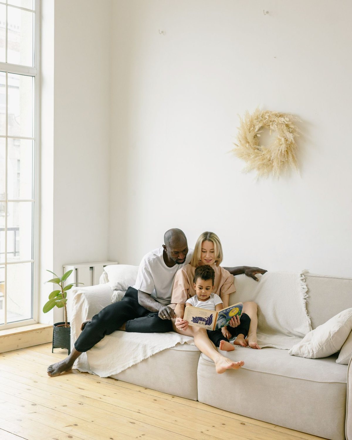 A family at home in a bright, clean living room