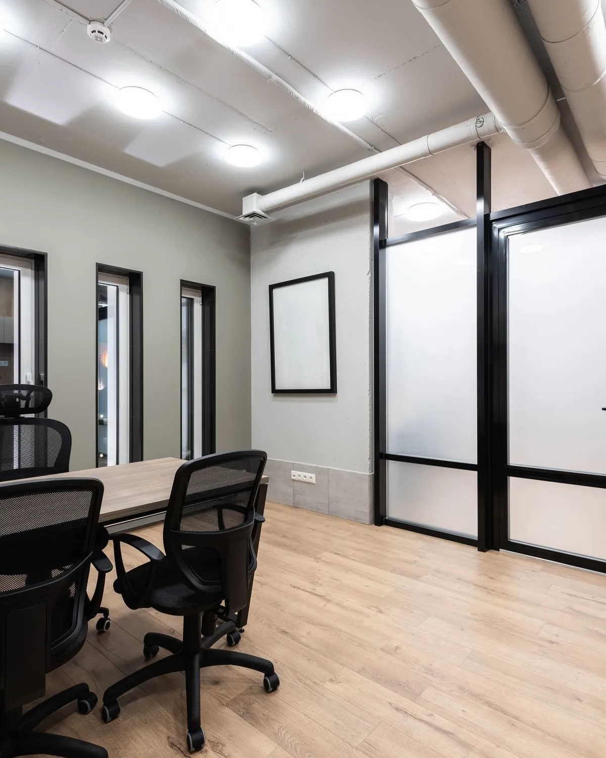 A clean, bright commercial meeting room with a conference table and glass doors, for commercial mold remediation in Falls Church, VA